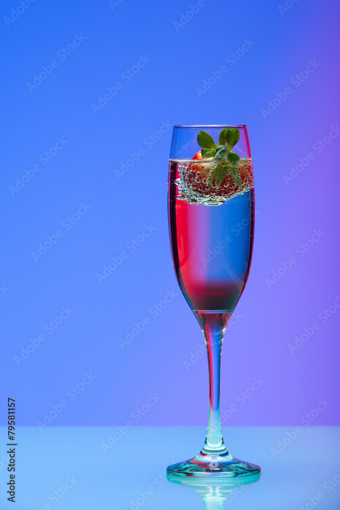Champagne glass with strawberry, studio shot with light effects