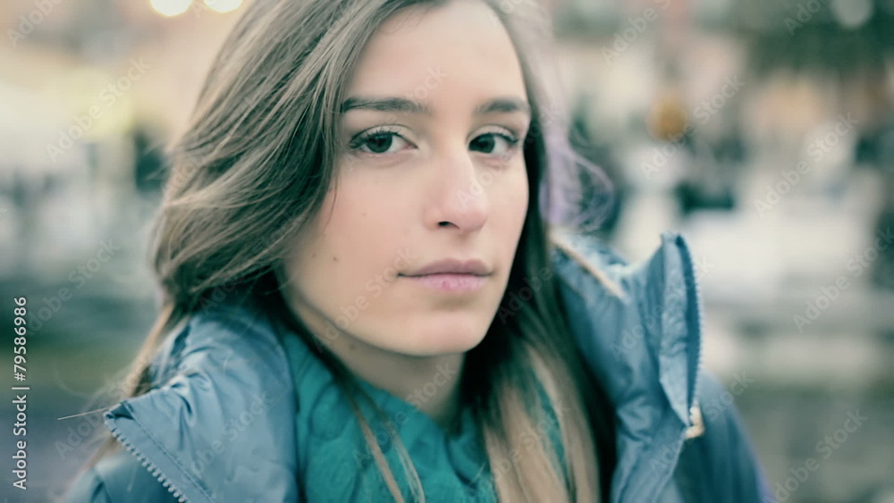 Pretty young woman in winter clothes looking at camera Pretty young woman in winter clothes looking at camera