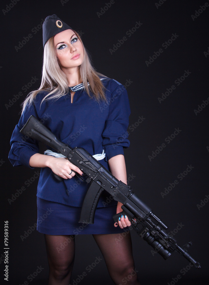 Woman in the marine uniform with an assault rifle Woman in the marine uniform with an assault rifle