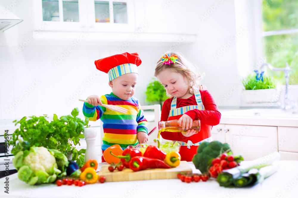 Kids cooking vegetables in a white kitchen Kids cooking vegetables in a white kitchen