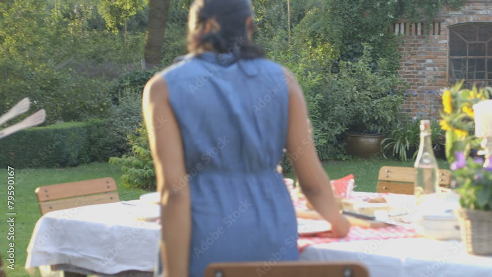 MS PAN Couple enjoying a barbecue and talking in domestic garden MS PAN Couple enjoying a barbecue and talking in domestic garden