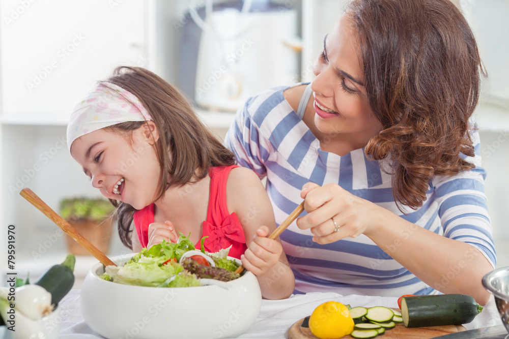Mother and daughter having fun in the kitchen Mother and daughter having fun in the kitchen