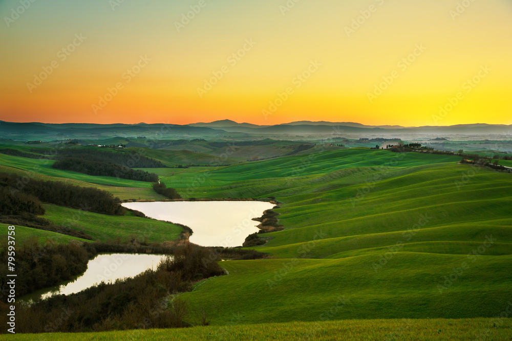 Tuscany, rural landscape on sunset, Italy. Lake and green fields Tuscany, rural landscape on sunset, Italy. Lake and green fields