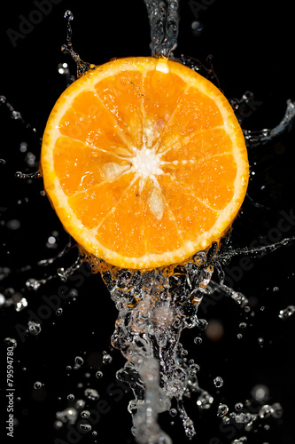 orange in water on a black background