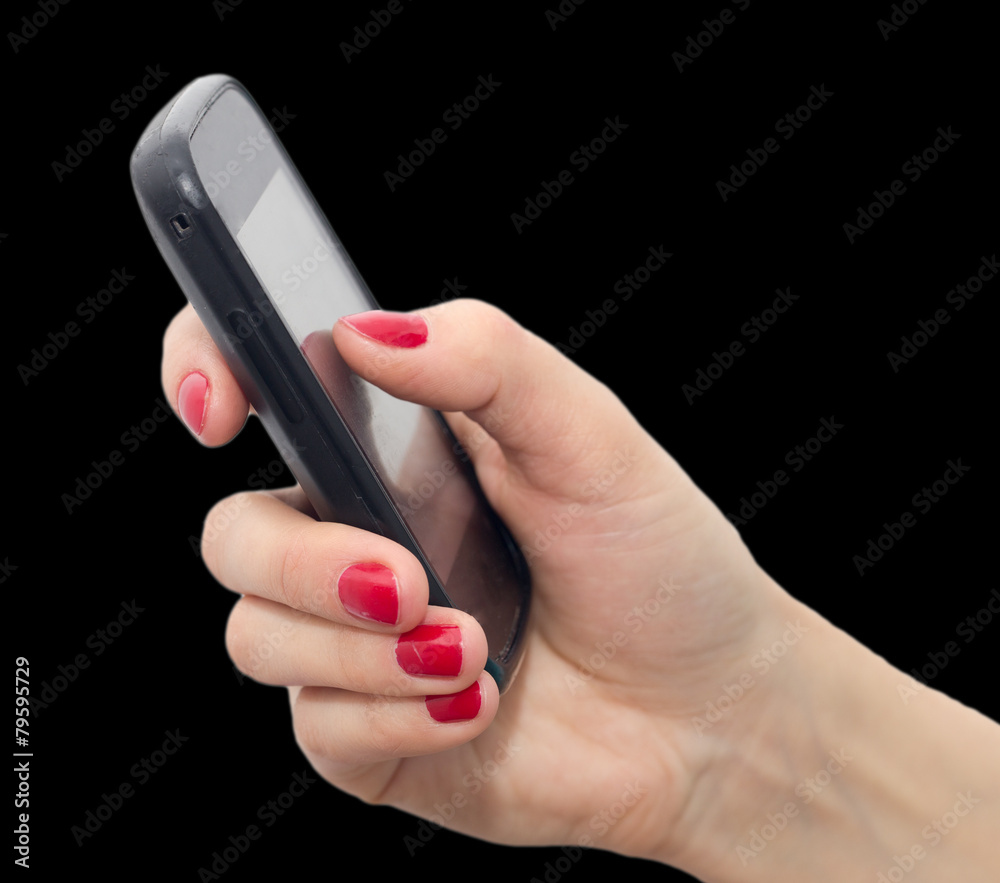 Fototapeta premium Cell phone in hand with red nail polish on a black background
