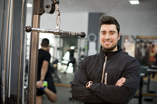 Obraz na plátně fitness personal trainer posing at gym