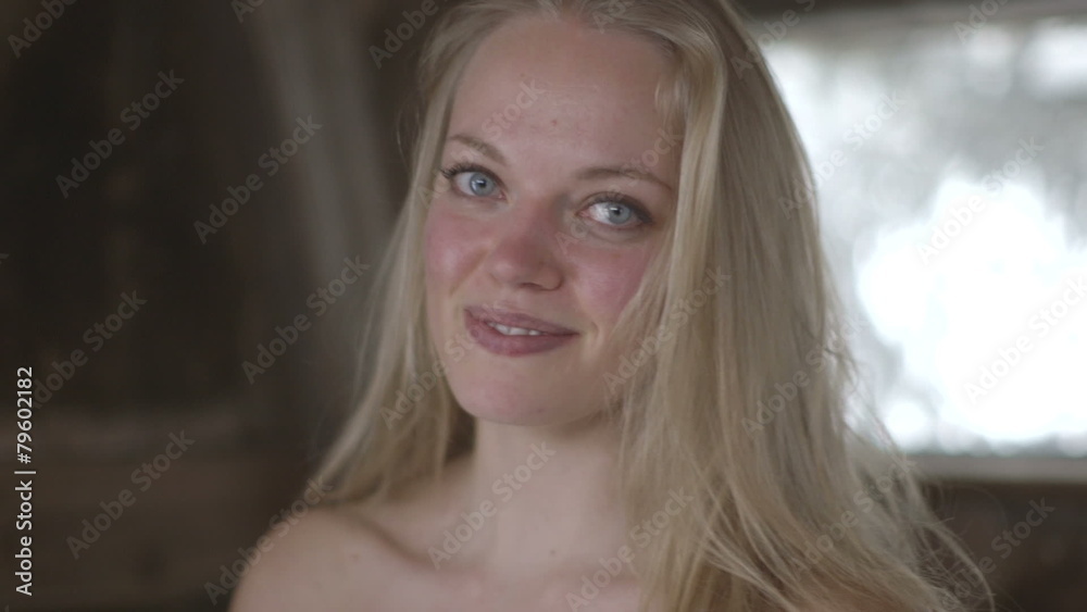 Young woman in sauna, smiling
