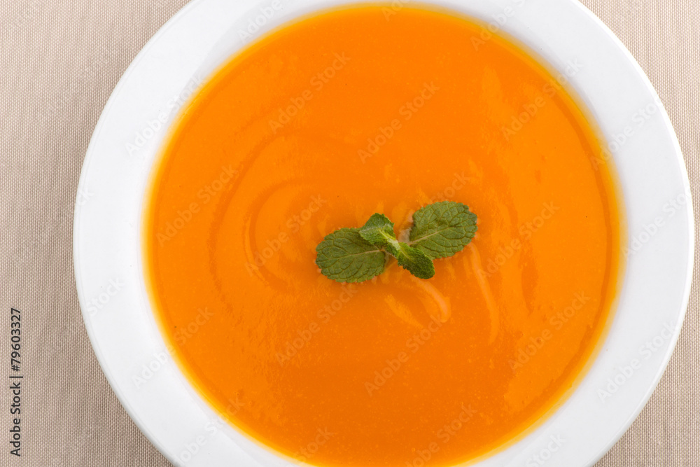 Delicious, healthy pumpkin soup in a white dish Delicious, healthy pumpkin soup in a white dish