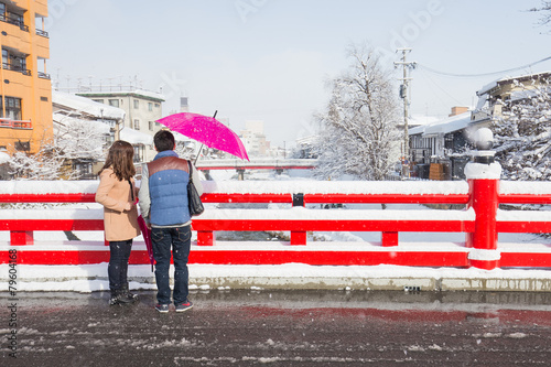 romantic scene of love couples partners at red Nakabashi bridge photo