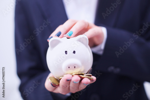 Business woman saving money in a piggybank