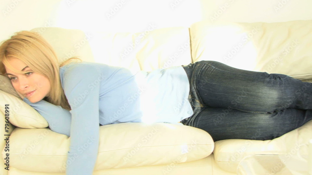 WS OF A YOUNG WOMAN WATCHING TELEVISION WS OF A YOUNG WOMAN WATCHING TELEVISION