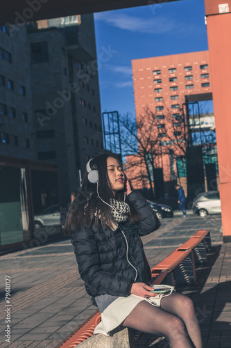 Young beautiful Chinese girl with headphones