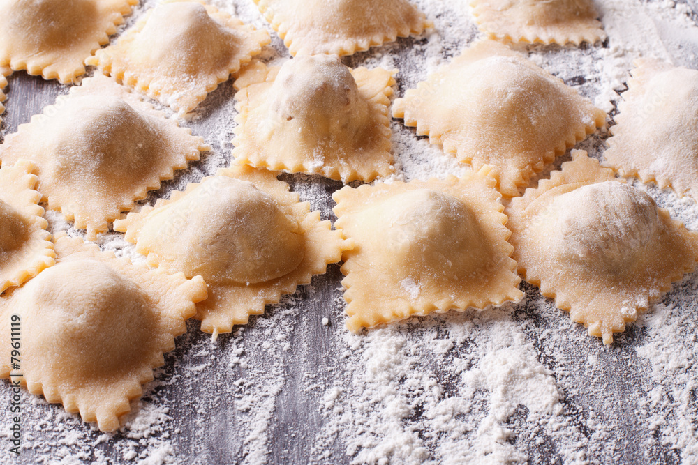 uncooked ravioli with flour on the table. horizontal uncooked ravioli with flour on the table. horizontal