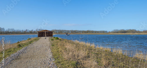 Bird hide along the shore of a lake