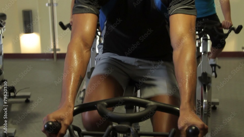 Group working out on bicycles in a gym Group working out on bicycles in a gym