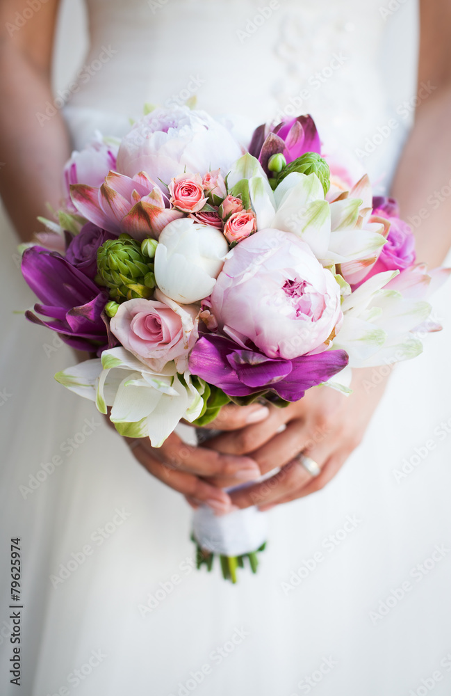 Beautiful wedding bouquet in hands of the bride Beautiful wedding bouquet in hands of the bride