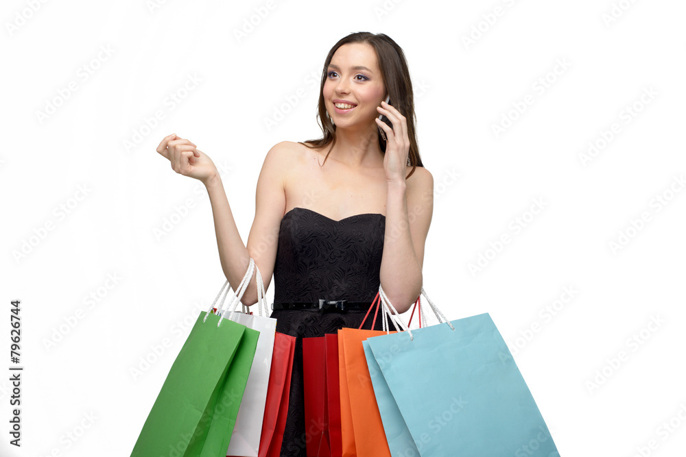 Caucasian young woman after shopping with bags and phone Caucasian young woman after shopping with bags and phone