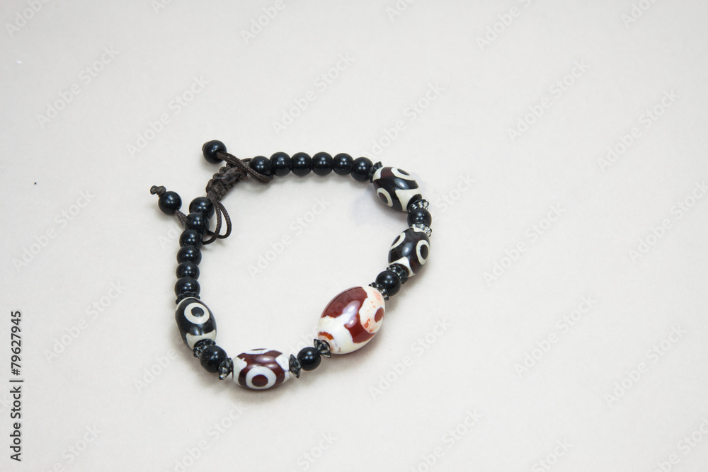 Popular Buddhist bracelet shamballa on a white background. Popular Buddhist bracelet shamballa on a white background.