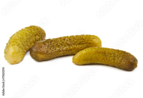 Three green pickles on white background