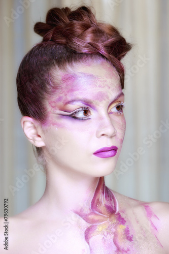 Portrait of young woman with creative make-up in spring style