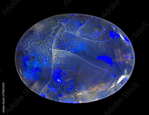Photos Polished black opal isolated on black.
