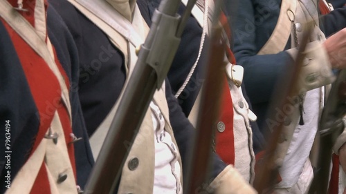 Soldiers line up during a revolutionary war battle reenactment