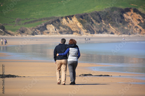 pareja caminando por la playa de oyambre en cantabria