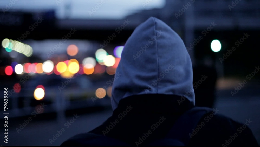 young man walking down a street