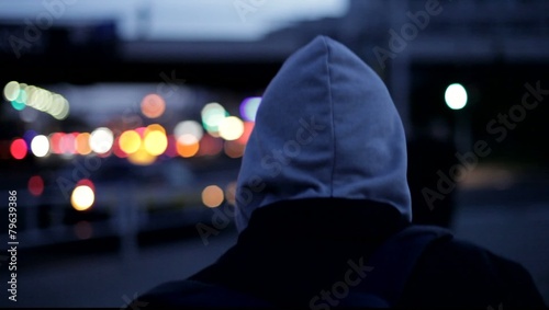 young man walking down a street