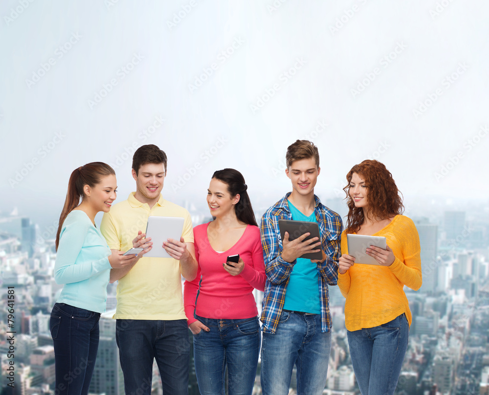 group of teenagers with smartphones and tablet pc group of teenagers with smartphones and tablet pc