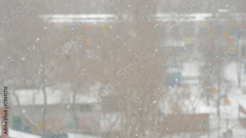 swirling flakes of snow on blurred background