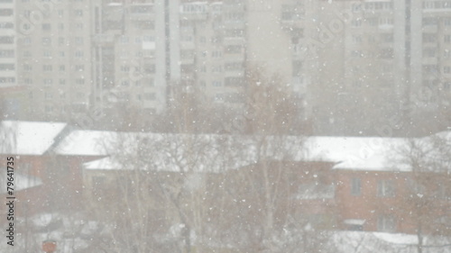 swirling flakes of snow on blurred background