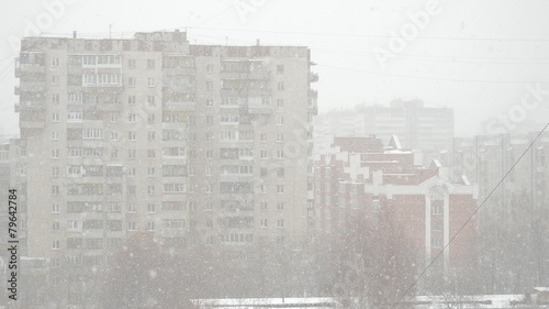 Snow flakes swirling in the big city
