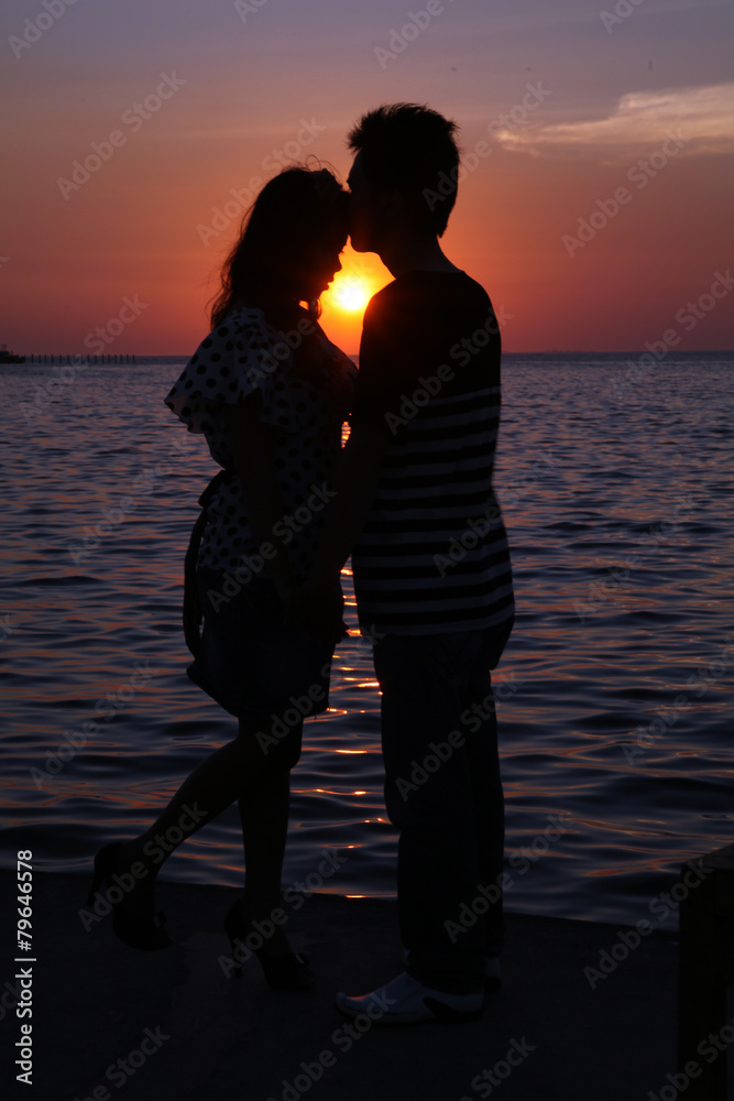 silhouette couple at beach sunset 