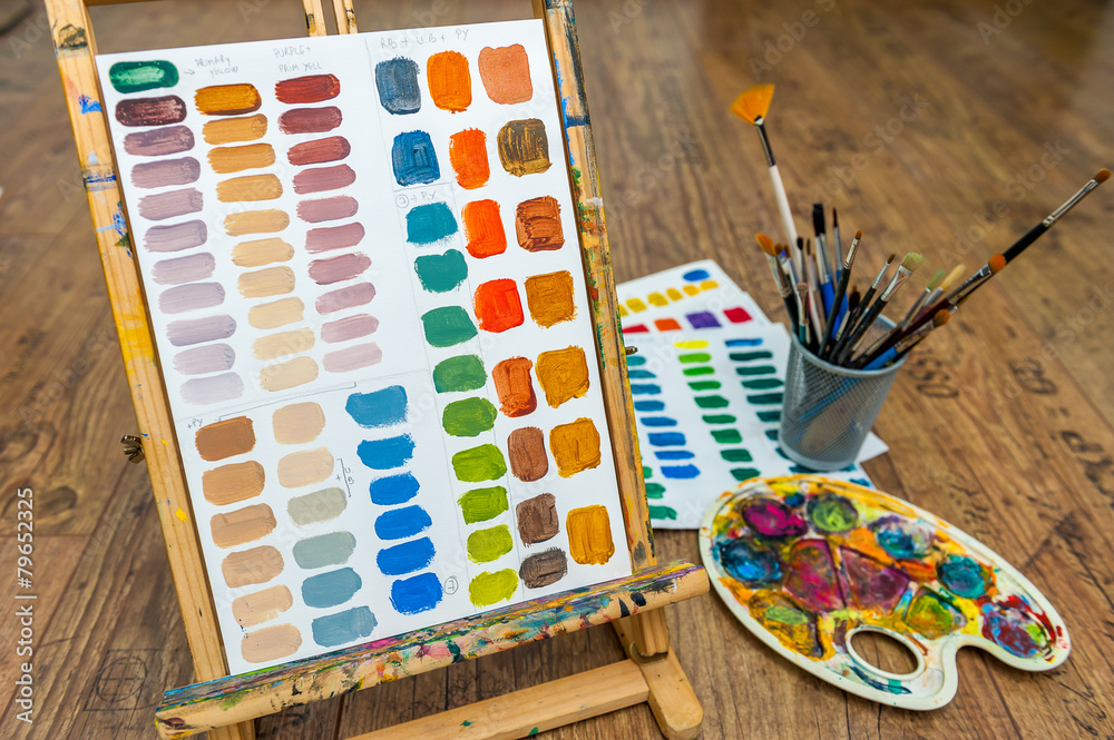 Fototapeta premium easel with color mixing exercise on paper