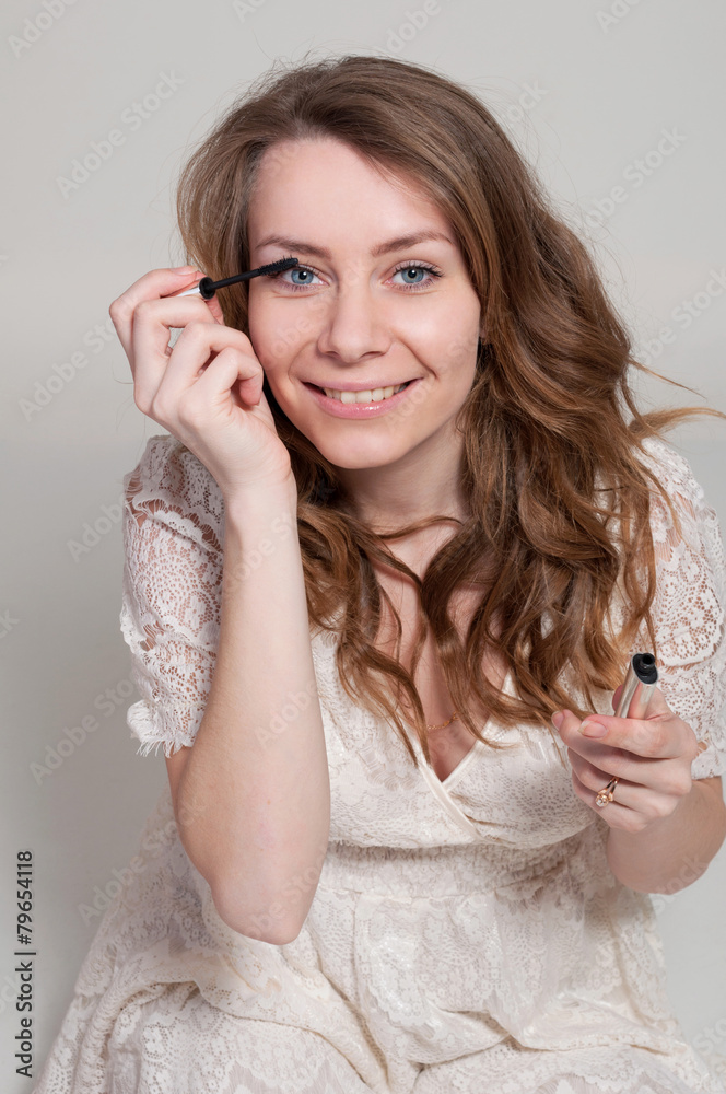 Portrait of young beautiful woman with brush for make-up Portrait of young beautiful woman with brush for make-up