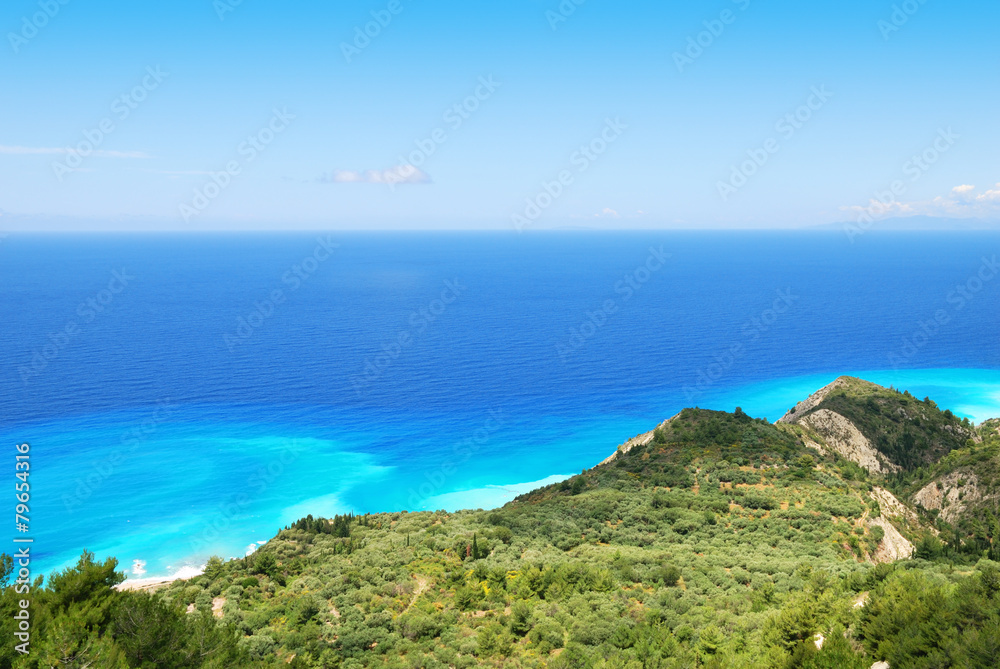 Green hillside and vast blue sea on the island of Lefkada, Greec Green hillside and vast blue sea on the island of Lefkada, Greec