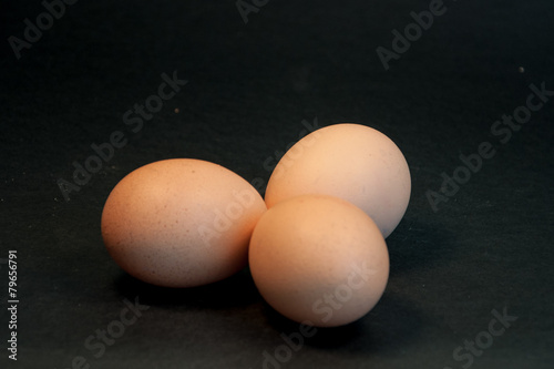 Three eggs on the black background