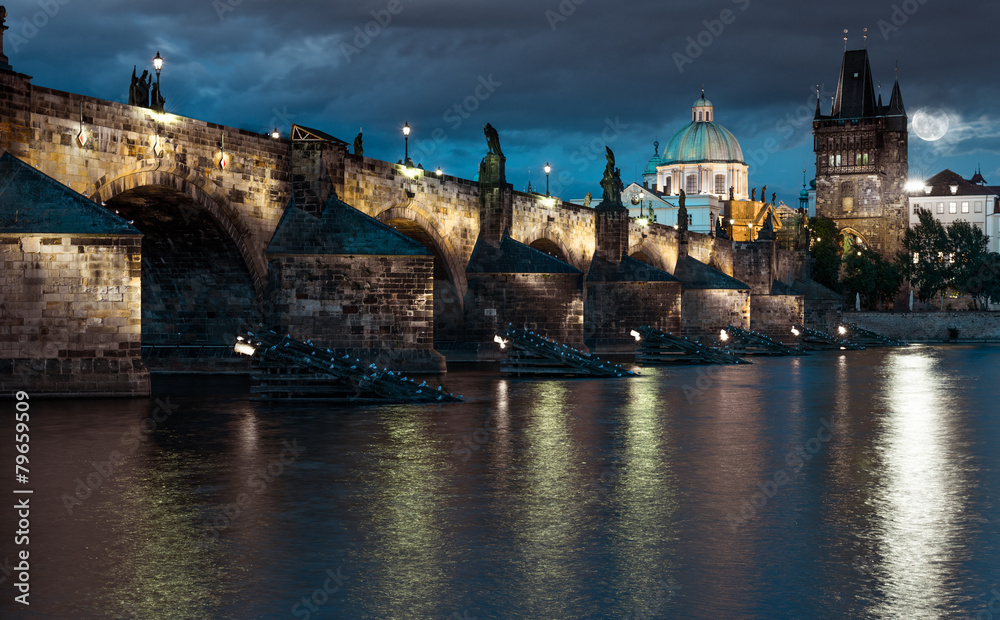 Charles Bridge reflected in Vltava river in Prague