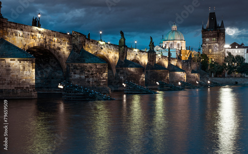 Charles Bridge reflected in Vltava river in Prague