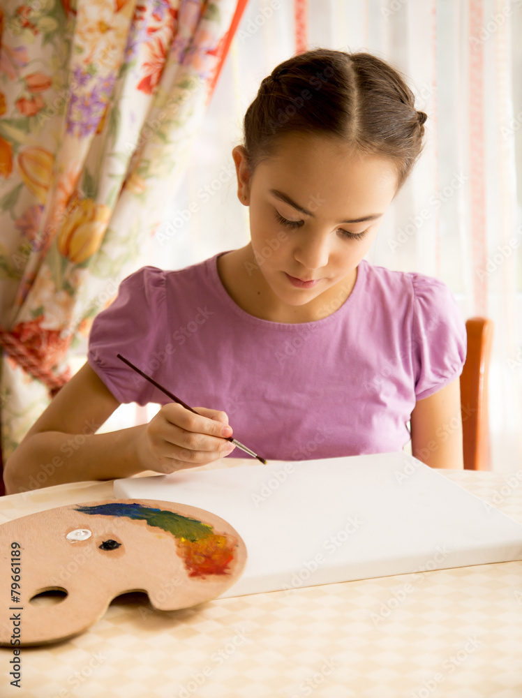 concentrated girl drawing on canvas by oil paints concentrated girl drawing on canvas by oil paints
