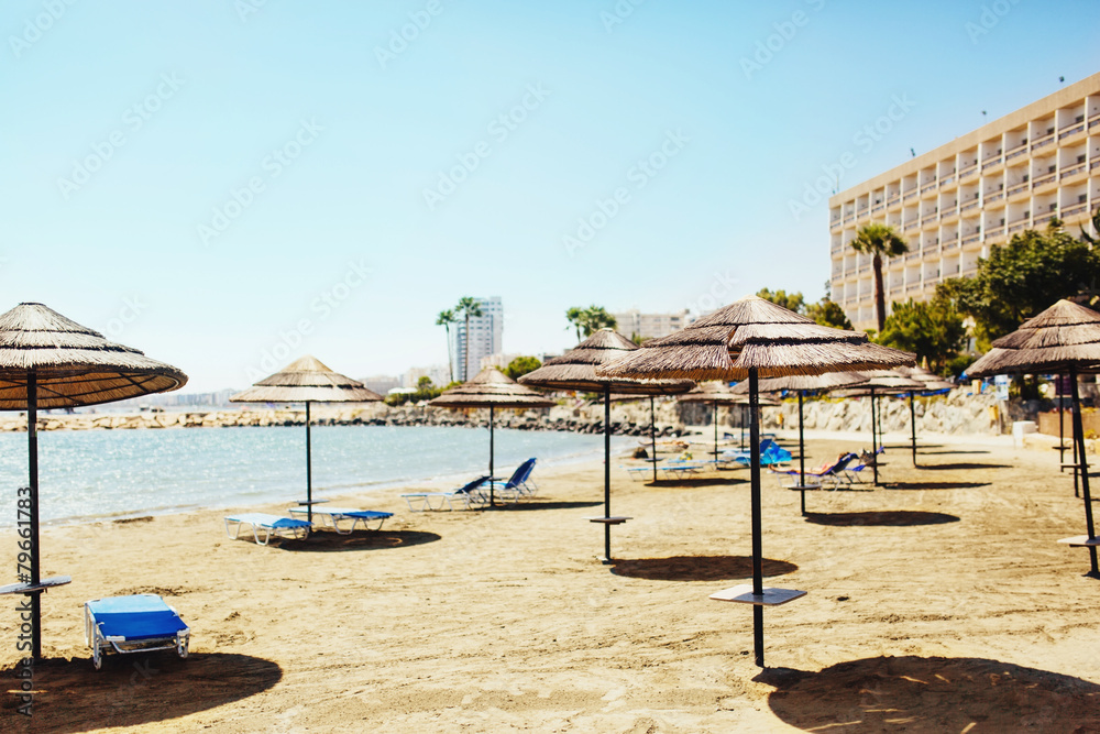 Sunshade Umbrellas with lounge chairs on the beach Sunshade Umbrellas with lounge chairs on the beach