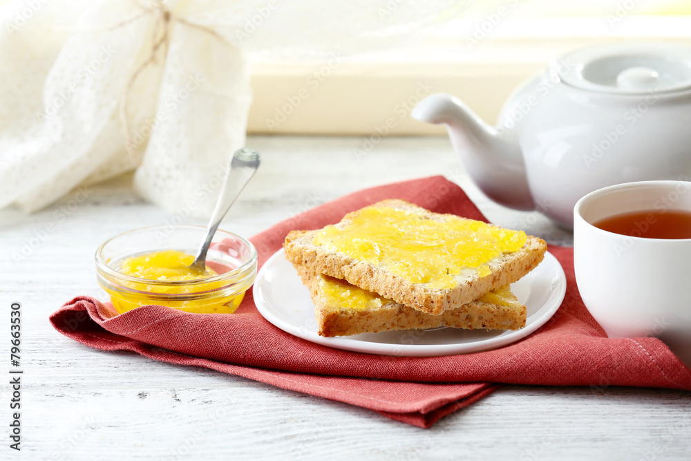 Toasts with honey on plate and cup of tea on light background Toasts with honey on plate and cup of tea on light background