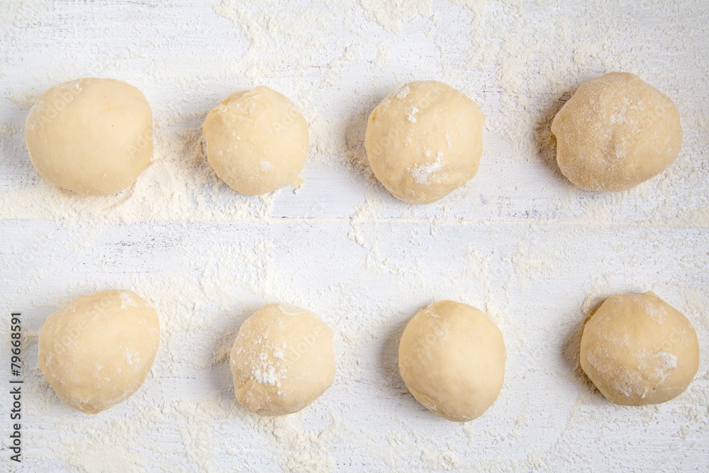 Rolled balls of dough on white table Rolled balls of dough on white table