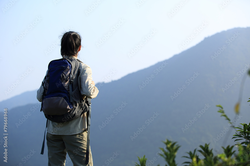 cheering woman hiker open arms at mountain peak cheering woman hiker open arms at mountain peak