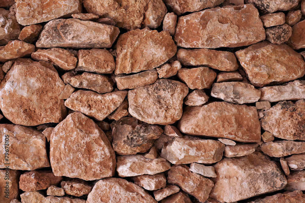 wall formed by various sizes of stones wall formed by various sizes of stones