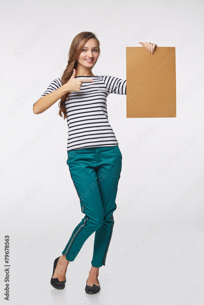 Full length of beautiful woman standing behind, holding white bl Full length of beautiful woman standing behind, holding white bl