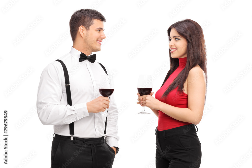 Couple drinking red wine and talking to each other Couple drinking red wine and talking to each other