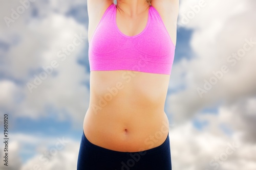 Composite image of smiling toned woman stretching hands on beach