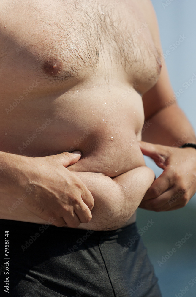 Young man with excessive stomach fat Young man with excessive stomach fat